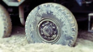 stuck-mired-wheel-in-sand-ditch-car-auto